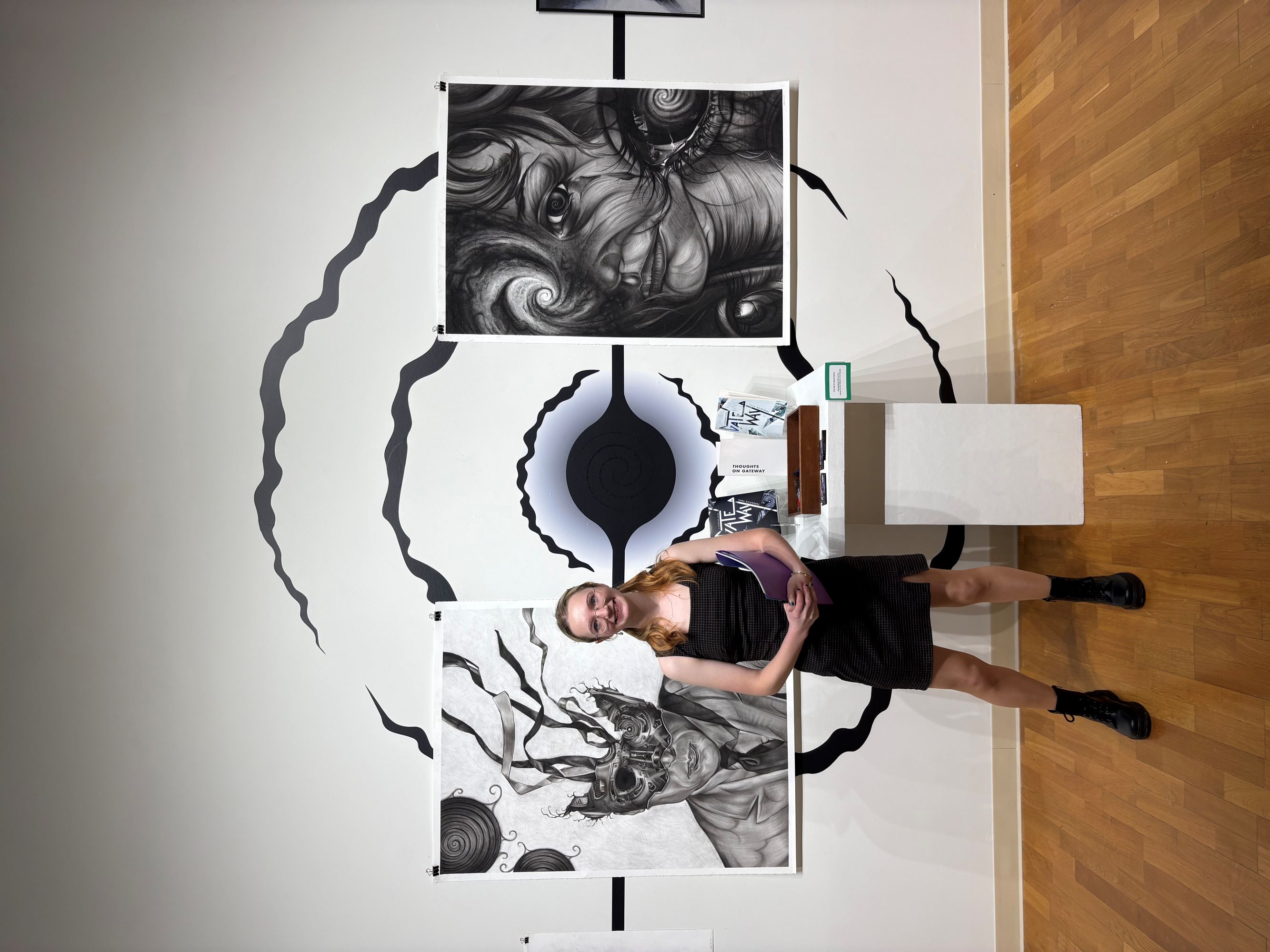 student in front of her senior art show