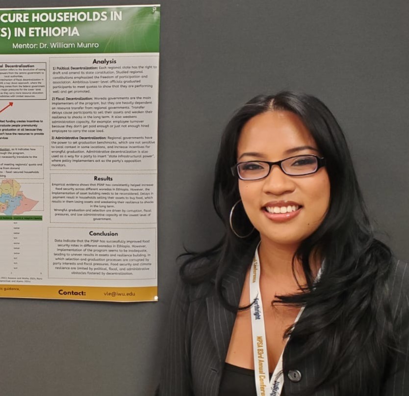 Student standing in front of a research poster