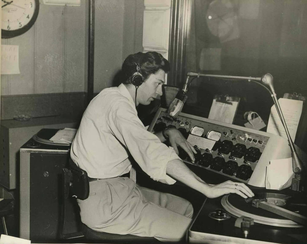Student operating sound board at WESN