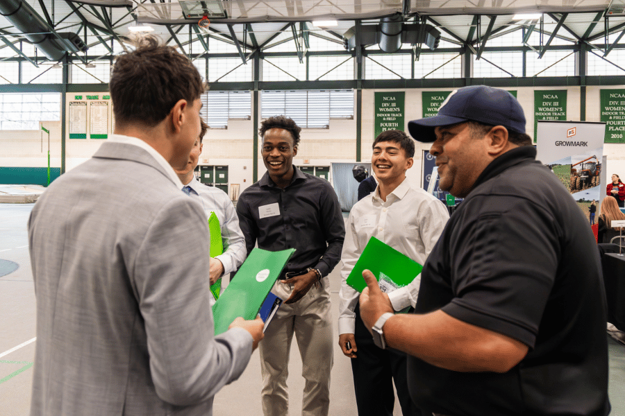 career fair Students chat with representatives from a business at an IWU career fair
