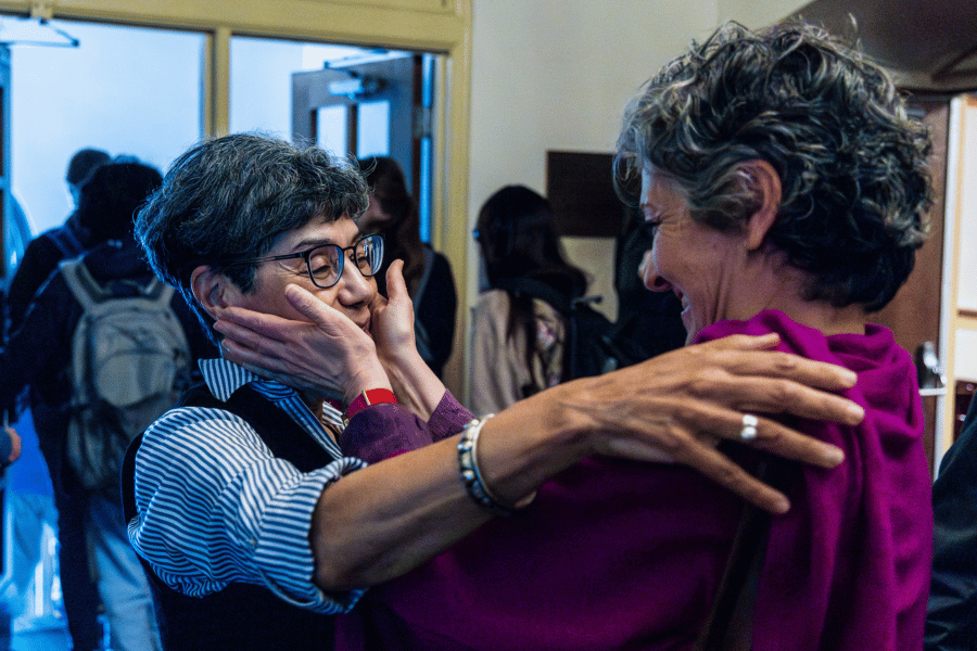Kemp 2 A colleague cups the face of Zahia Drici in congratulations after she received an award