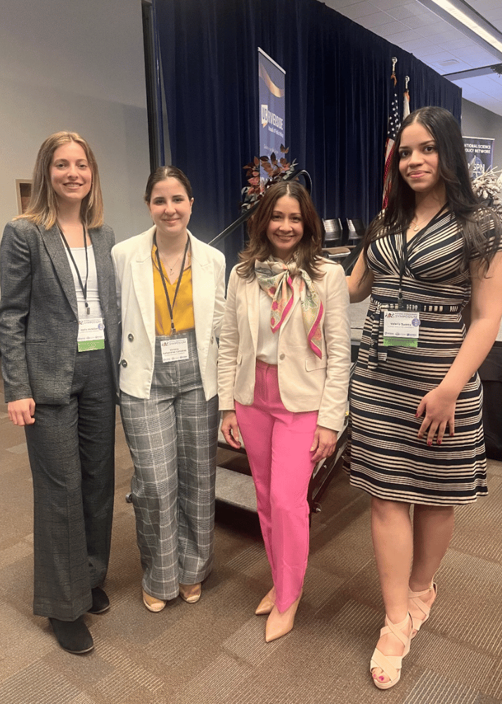 NSP IWU students standing with keynote speaker at national science to policy symposium