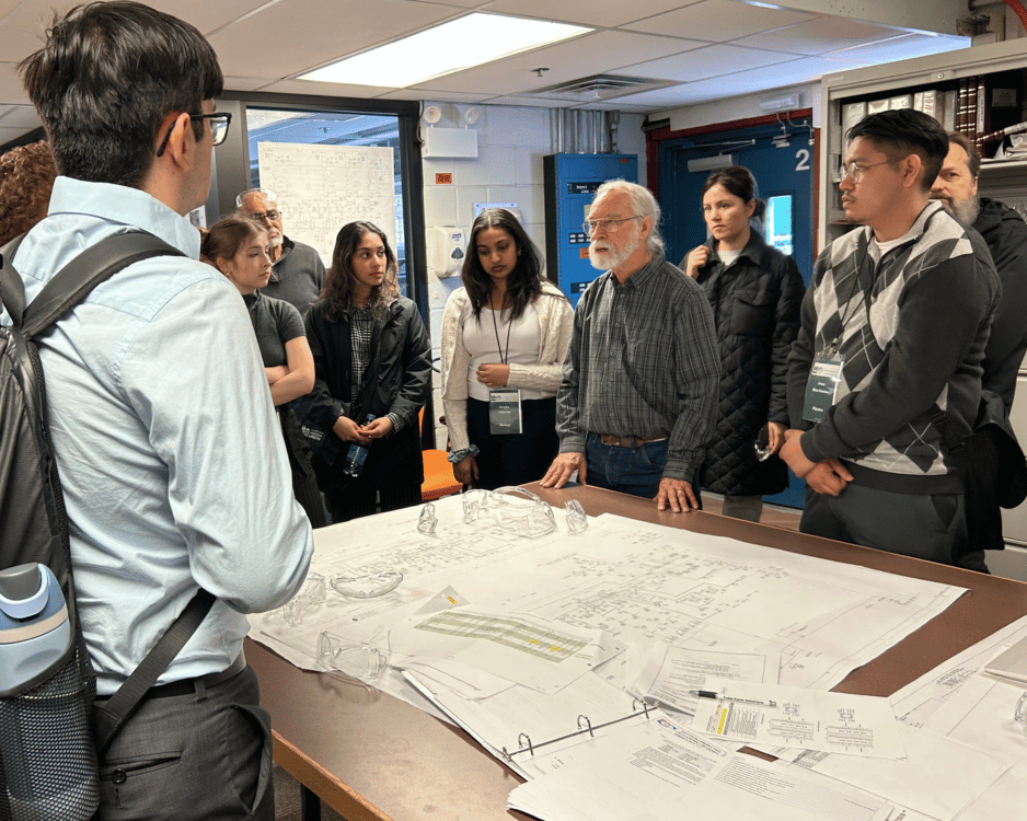 IWU students stand at table to hear information shared by a senior scientist at Fermilab