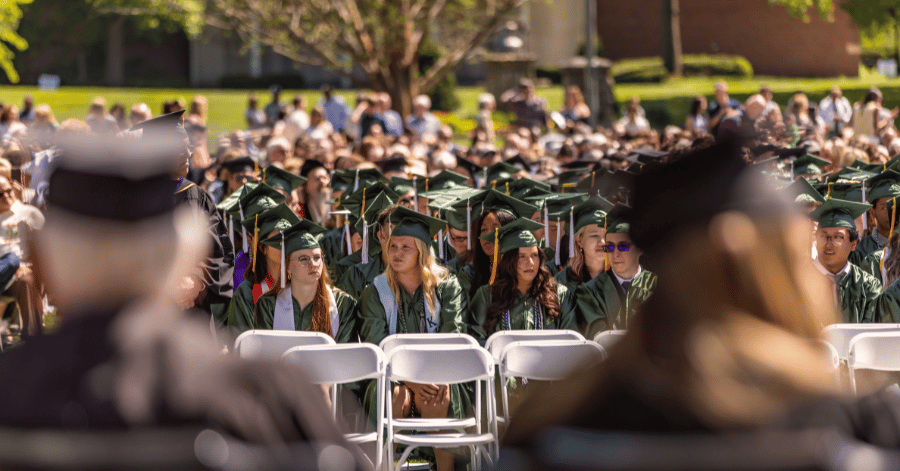 Graduates in caps and gowns on the quad during the 2024 IWU commencement