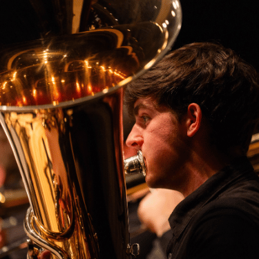 Student playing brass instrument