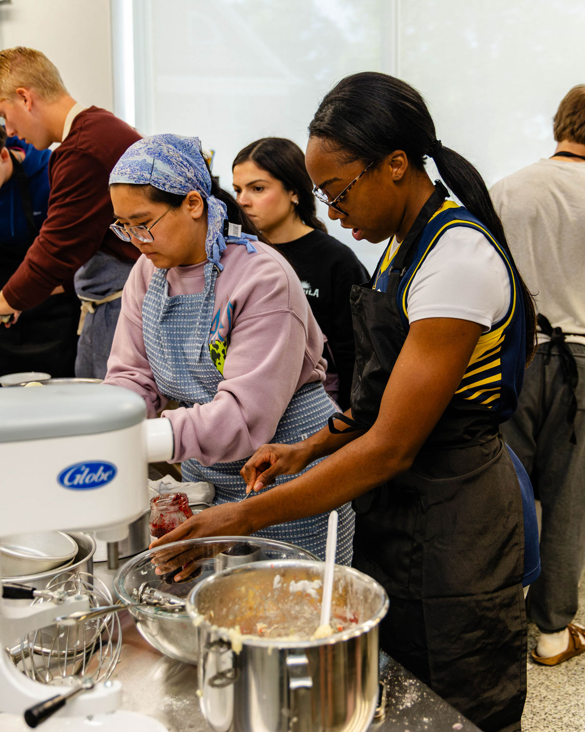 A group works on adding the final touches to their cake batter.