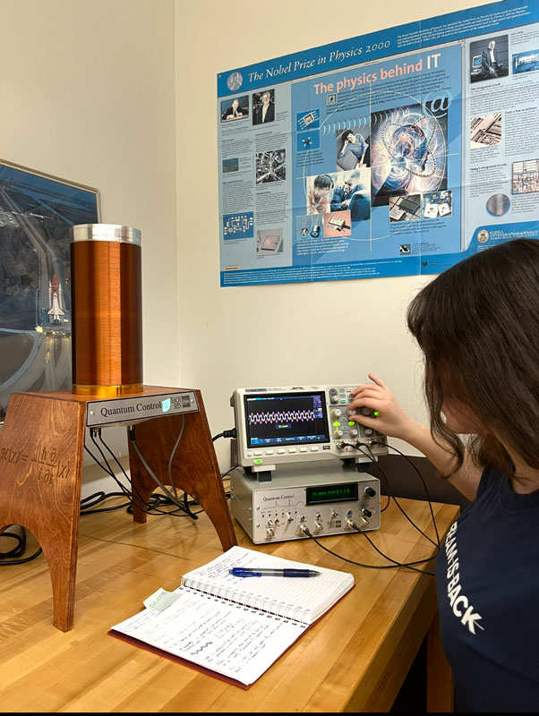 Physics student working with a machine