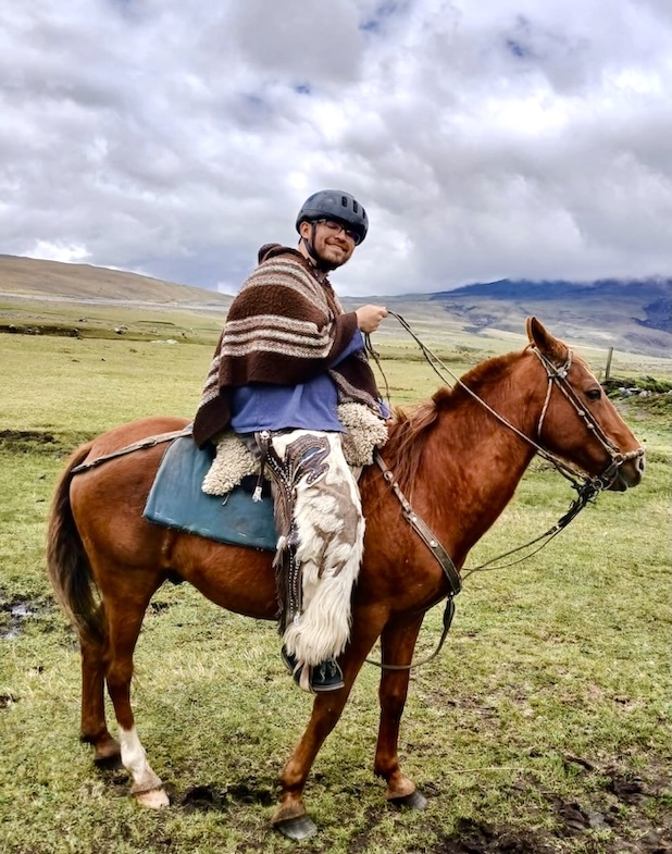 person on horse in a grassy field